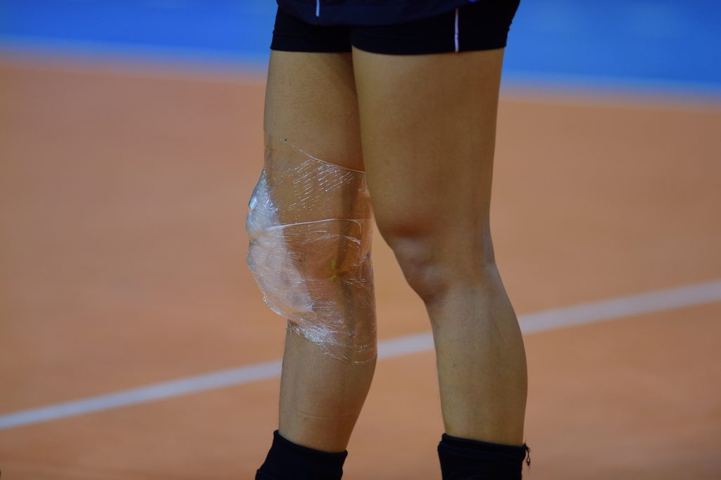 Athlete with ice pack strapped to knee