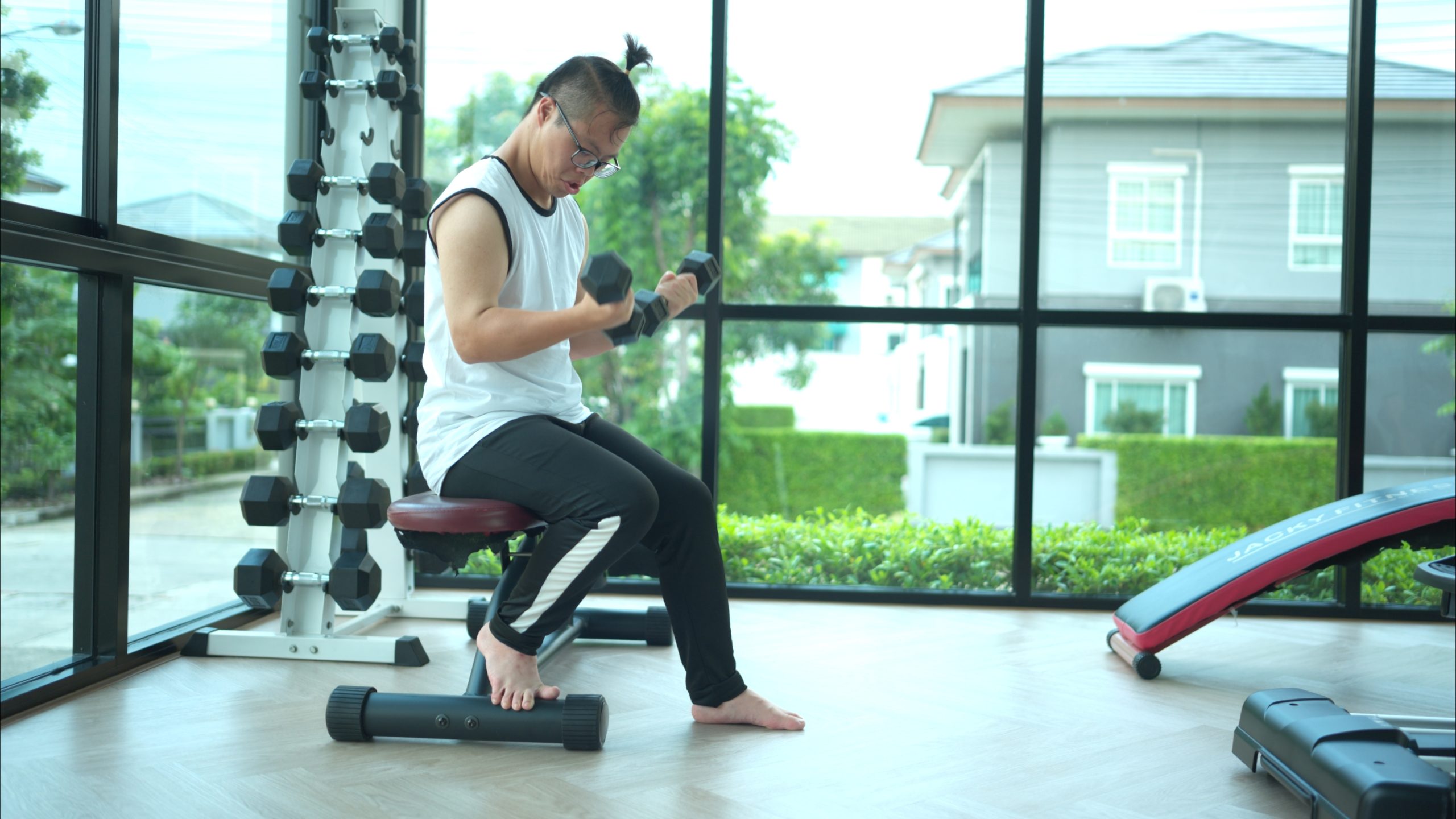 Autism and exercise: young autistic man lifting weights